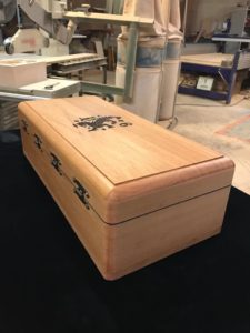 A wooden box with a black and white design on it.