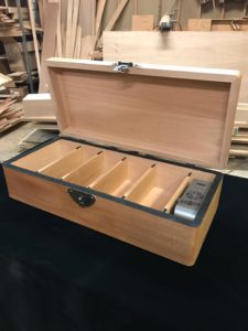 A wooden box with compartments inside of it.