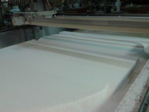 A machine is making foam sheets in the factory.