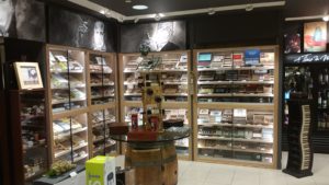 A store with shelves full of cigars and boxes.