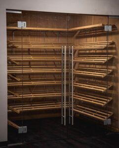 A corner of a room with shelves and racks.