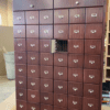 A large wooden cabinet with many drawers in it.