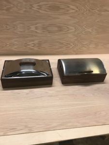 Two boxes are sitting on a table next to each other.