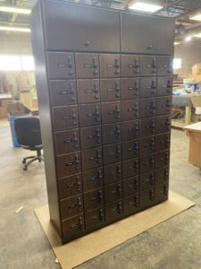 A large wooden cabinet with many drawers in it