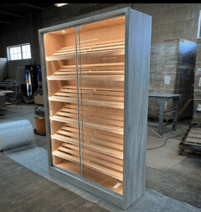 A large wooden cabinet with glass doors and shelves.