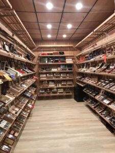 A large room filled with lots of shelves full of cigars.