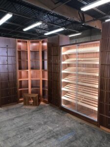 A room with shelves and a chair in it