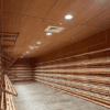 A large empty room with wooden shelves and lights.