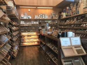 A room filled with lots of shelves full of different types of cigars.