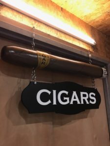A cigar hanging from the ceiling of a room.