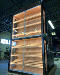 A large wooden shelf in the middle of a room.