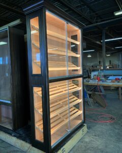 A large wooden shelf in the middle of an industrial setting.