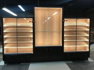 A room with three glass cases and one large display case.