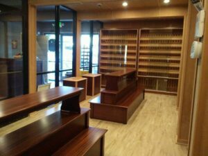 A room with many wooden tables and shelves.