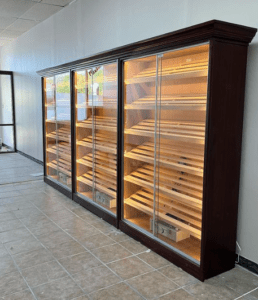 A room with three large cabinets filled with wooden items.