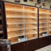 A room filled with two glass cases of cigars.