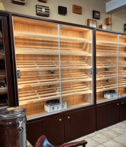 A room filled with two glass cases of cigars.