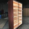 A large wooden cabinet with lights on the inside.
