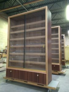 A pair of bookcases with glass doors and drawers.