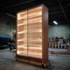 A large wooden cabinet with lights on top of it.