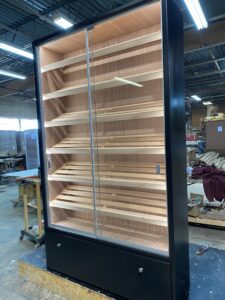 A large display case with wooden shelves and glass doors.