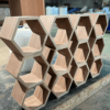 A wooden shelf with hexagonal shapes on it.
