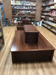 A wooden bench in the middle of a store.