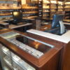 A store with many shelves of cigars and a cash register.