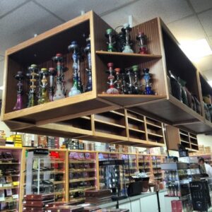 A store with shelves of glass vases and bottles.