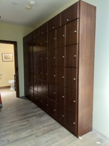 A room with many wooden lockers in it