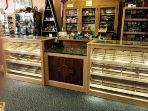 A store with many shelves of cigars in it.