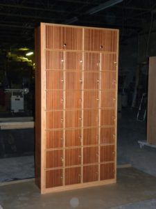 A large wooden locker with many compartments.