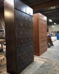 A couple of wooden cabinets in an industrial setting.
