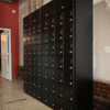 A room with many black lockers in it