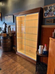 A large display case in the corner of a room.