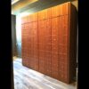 A large wooden cabinet with many doors and drawers.