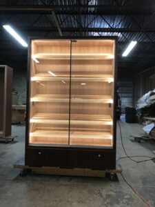 A large display case with lights on top of it.