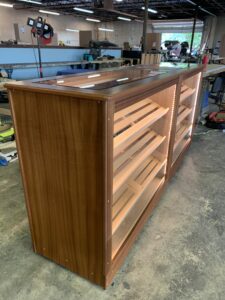A wooden shelf in the middle of a room.