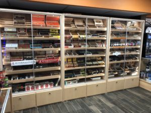 A room filled with lots of shelves full of different types of cigars.