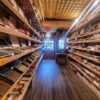 A long wooden shelf filled with lots of cigars.