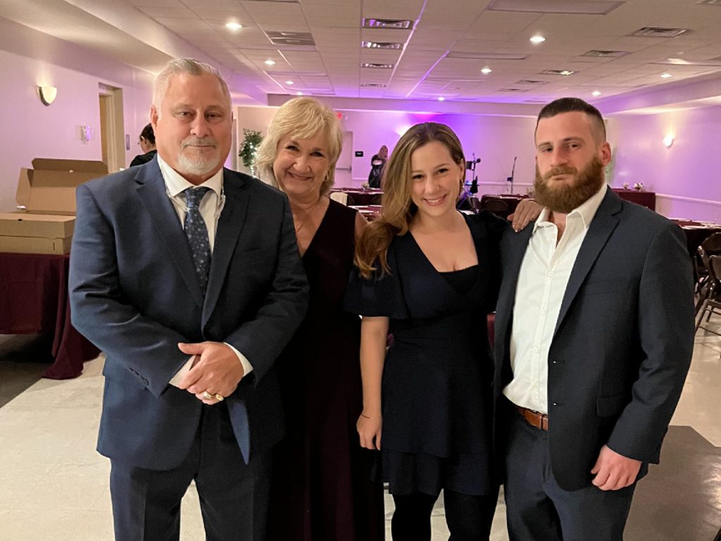 four people posing for a picture.