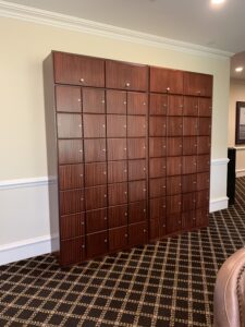 A room with many wooden lockers in it