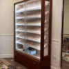 A large display case with glass doors and drawers.