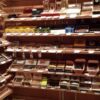 A large selection of cigars on display in a store.