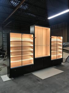 A large display case with lights on top of it.