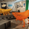 A room with two orange and yellow sculptures.
