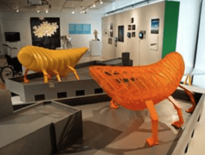 A room with two orange and yellow sculptures.