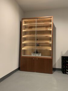A large wooden cabinet with glass doors and shelves.