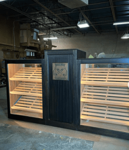 A large black wooden display case with shelves.