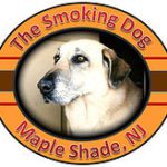 A dog sitting in front of the smoking dogs logo.